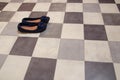 Light and comfortable blue women`s shoes on  black and white checkered floor Royalty Free Stock Photo