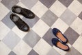 Light and comfortable blue women`s shoes and man`s shoes on  black and white checkered floor Royalty Free Stock Photo