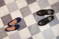 Light and comfortable blue women`s shoes and man`s shoes on  black and white checkered floor Royalty Free Stock Photo