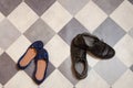 Light and comfortable blue women`s shoes and man`s shoes on  black and white checkered floor Royalty Free Stock Photo