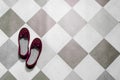 Light and comfortable red women`s shoes on  black and white checkered floor Royalty Free Stock Photo