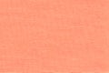 Light coral background from a textile material with wicker pattern, closeup. Royalty Free Stock Photo