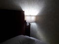 Light at the corner of bed room,shadow in dark blur bed room.