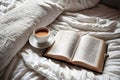Light cozy bedroom, Coffee or tea cup and an open book on the bed. Royalty Free Stock Photo