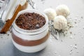 Creamy Vanilla and Chocolate Mousse Dessert in Jar with Coconut Balls On a Gray Background. Concept Valentine`s Day