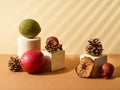 On a light and dark beige background, the original composition. Geometric shapes, fruits and cones. Shop window, interior decor,