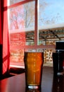 Light and Dark Cold Beer on Classic Tall Glasses Placed on Wooden Table Near Window at the Pub