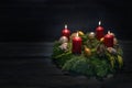 Light in the dark on fourth advent, natural green wreath with red candles, four are burning, Christmas decoration and cookies, Royalty Free Stock Photo