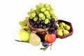 Light and dark grapes in a wooden bowl with an apple pear plum a Royalty Free Stock Photo