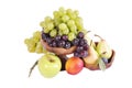 Light and dark grapes in a wooden bowl with an apple pear plum a Royalty Free Stock Photo