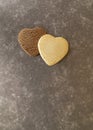 Light and dark heart-shaped cookies on a dark background, copy space