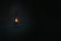 Light in the darkness. Blurred background image of a glowing lantern against dark night time. Light in dark forest / wood. Light i