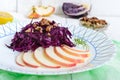 Light diet vegan salad of red cabbage, apple and walnuts. The Lenten dish. Royalty Free Stock Photo