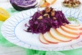 Light diet vegan salad of red cabbage, apple and walnuts. Royalty Free Stock Photo