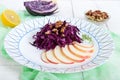 Light diet vegan salad of red cabbage, apple and walnuts. Royalty Free Stock Photo