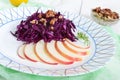 Light diet vegan salad of red cabbage, apple and walnuts. Royalty Free Stock Photo