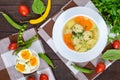 Light dietary soup with meat balls, vegetables, fusilli and boiled eggs on a dark wooden table. Royalty Free Stock Photo