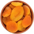 Light dried apricots in a brown ceramic bowl isolated on white background Royalty Free Stock Photo