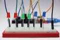 Light emitting diodes of red, green and blue color on a breadboard connected by jumper cables and controlled by a microcontroller Royalty Free Stock Photo