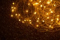 Light-emitting diodes on a wire, Christmas lights arranged on a shiny dark background Royalty Free Stock Photo