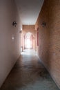 Light at the end of corridor. Ancient walk way made from red brick wall. Royalty Free Stock Photo