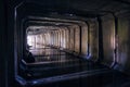 Light at the end of dark flooded dirty sewer tunnel. Turn of tunnel Royalty Free Stock Photo