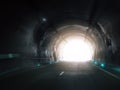 Light at end of dark highway tunnel with glowing exit. Hope, direction, breakthrough and progress, modern transportation Royalty Free Stock Photo