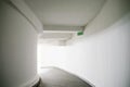 Light at end of tunnel. Long rounded corridor with white walls Royalty Free Stock Photo