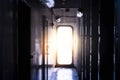 Light entering through open door to a dark empty room Royalty Free Stock Photo