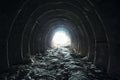 Light and exit in the end of dark long tunnel or corridor, way to freedom concept. Industrial round chalk mine passage Royalty Free Stock Photo