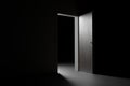 Light falls through a half-open door in total darkness Royalty Free Stock Photo