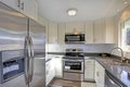 Light filled home interior features small compact kitchen