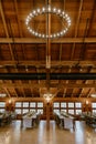 Light fixture hanging from rafter ceiling in rustic barn reception hall