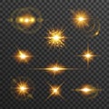 Light flare set in golden color isolated on transparent background. Sun rays, glowing stars, sparkles with glow effect Royalty Free Stock Photo