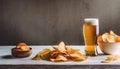 Light foamy beer, potato crisps on wooden background, chips snack and cold bar beverage, food and drink Royalty Free Stock Photo