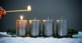 Light four advents candles with matches Royalty Free Stock Photo