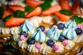 Light and fresh cake. Refined dessert made from meringue topped with low-fat whipped cream, mint leaves and strawberries