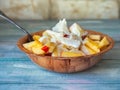 Light fruit salad with natural yogurt in a deep cup with a spoon Royalty Free Stock Photo