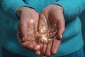 Light garland in women hands. Light bulbs in hands Royalty Free Stock Photo