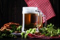 Light german beer poured into big glass, fresh green hops and bo Royalty Free Stock Photo