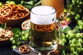 Light german beer poured into big glass, fresh green hops and bo Royalty Free Stock Photo