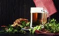 Light german beer poured into big glass, fresh green hops and bo Royalty Free Stock Photo
