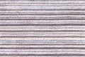 Light gray background of a knitted textile material. Fabric with a striped texture closeup. Royalty Free Stock Photo