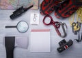 On a light gray background are objects for the traveler, a rope with a carbine, a map, a compass, an ax, a magnifying glass, a