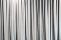 Light gray curtain background wallpaper. Abstract white fabric texture for decoration. Luxury vertical clean and smooth cloth