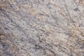 Light gray granite with dark veins and yellow blotches, close-up of a flat polished natural stone surface Royalty Free Stock Photo