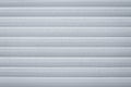 Light gray metallic jalousie. Texture of corrugated metal striped surface. Dirty ribbed background with straight lines. Copy space Royalty Free Stock Photo