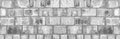 Light gray shabby brick block wall. Wide grungy background Royalty Free Stock Photo