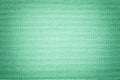 Light green background from a textile material with wicker pattern, closeup Royalty Free Stock Photo