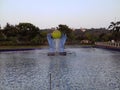 Light green big ball surrounded by Very big blue hands in the water